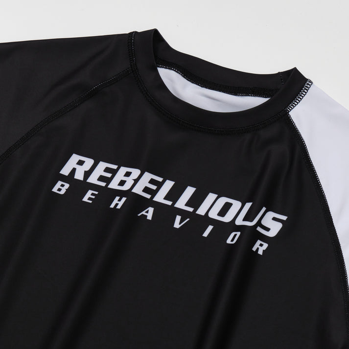 REBELLIOUS BEHAVIOR RBLS SPCS LOGO HALF RASH GUARD (BLACK)